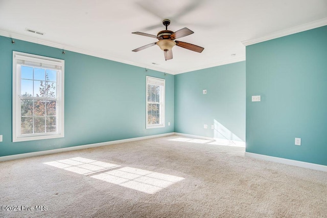 carpeted empty room featuring ceiling fan and crown molding