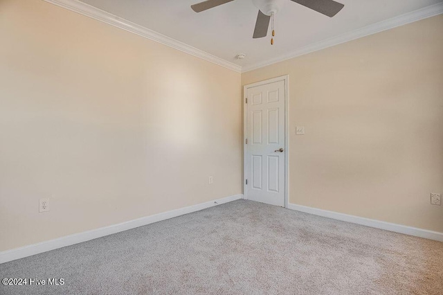 carpeted empty room with ceiling fan and crown molding