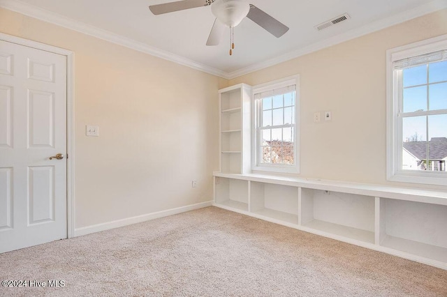 unfurnished room with crown molding, carpet floors, and ceiling fan