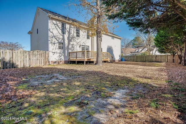 back of property with a wooden deck