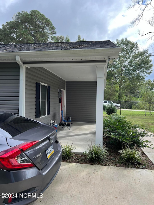 view of side of property with a carport