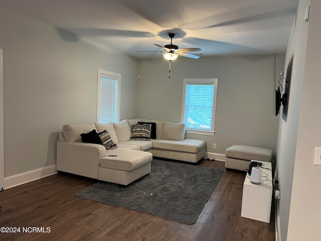 living room featuring ceiling fan and dark hardwood / wood-style flooring