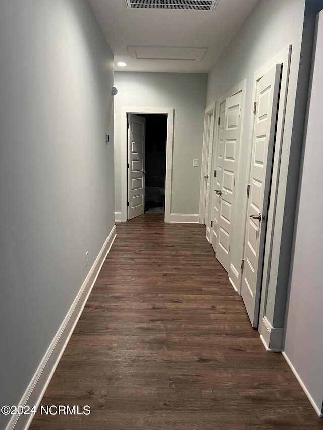 hall with dark hardwood / wood-style flooring