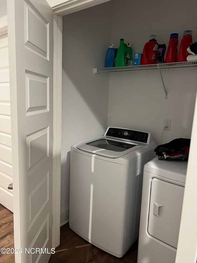 washroom with washer and clothes dryer and dark wood-type flooring