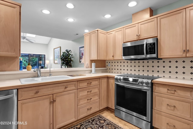 kitchen featuring light brown cabinetry, sink, appliances with stainless steel finishes, and tasteful backsplash