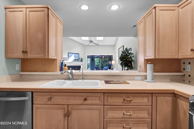 kitchen with appliances with stainless steel finishes, sink, and light brown cabinets