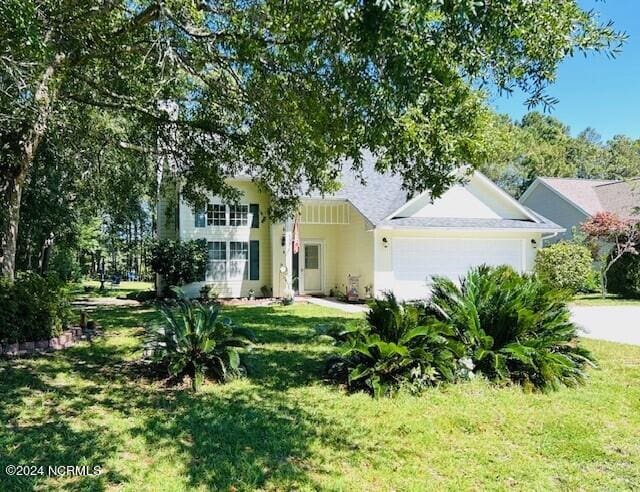 view of front of house with a garage and a front yard