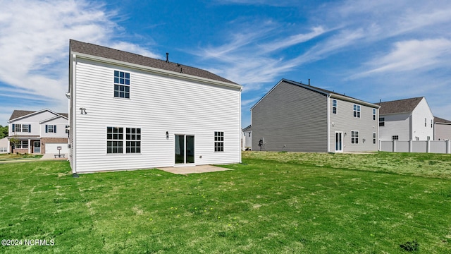 rear view of house with a patio area and a yard