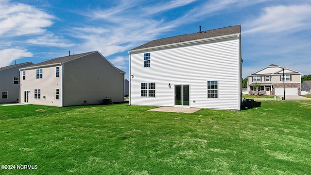 rear view of house with a patio and a lawn