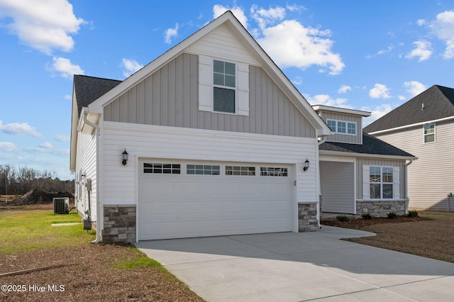 view of front of home featuring central air condition unit and a garage