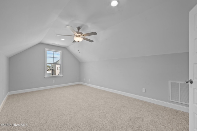 additional living space featuring ceiling fan, vaulted ceiling, and carpet