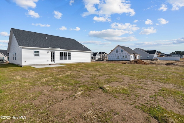 back of house with a yard and a patio area