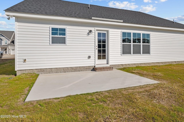 back of house with a yard and a patio area