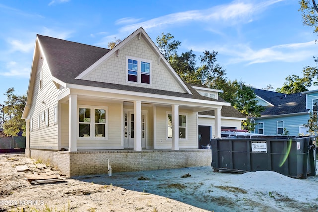 view of front of property featuring a porch and a garage