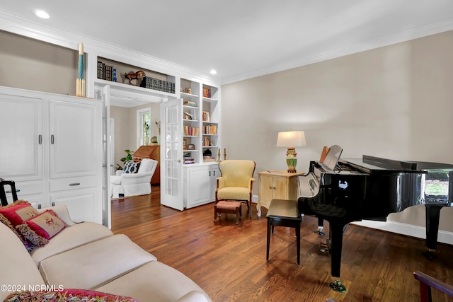 living room with crown molding and hardwood / wood-style flooring