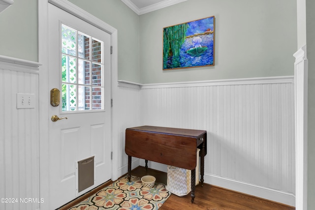 entryway with ornamental molding and hardwood / wood-style flooring