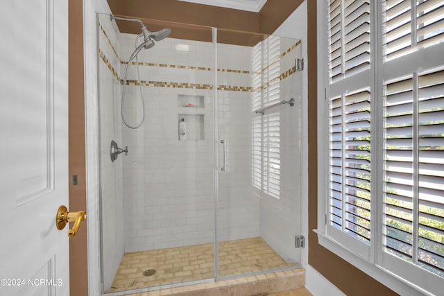 bathroom with a shower with door