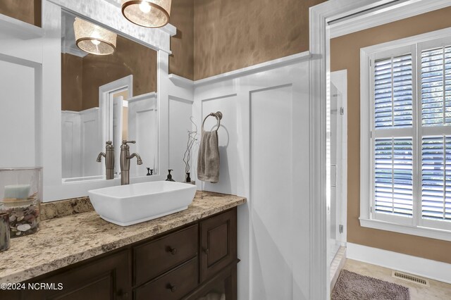 bathroom featuring tile patterned flooring and vanity