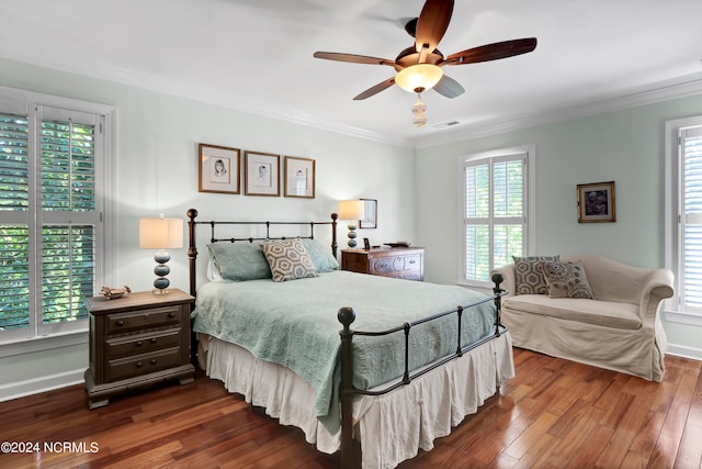 bedroom with ceiling fan, dark hardwood / wood-style floors, and multiple windows