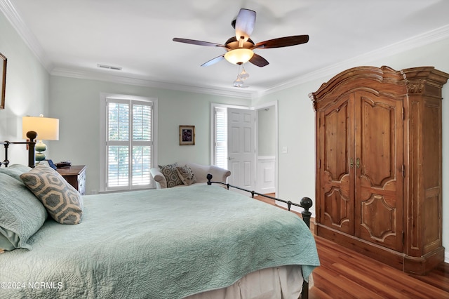 bedroom with ceiling fan, hardwood / wood-style flooring, and ornamental molding