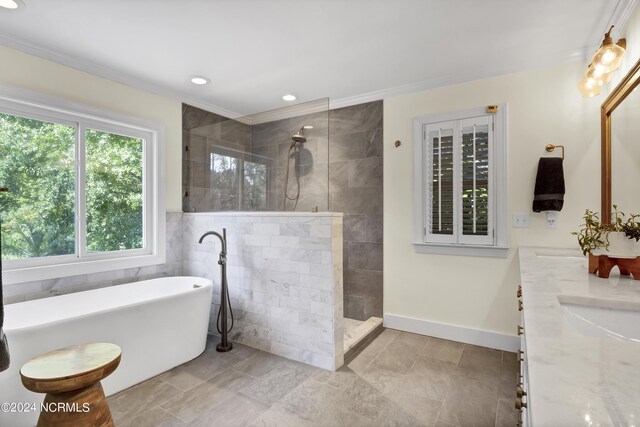 bathroom with separate shower and tub, ornamental molding, and vanity