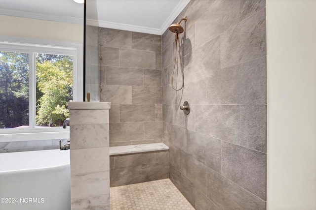 bathroom with tiled shower and crown molding