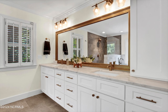 bathroom with tile patterned floors, tiled shower, ornamental molding, and vanity