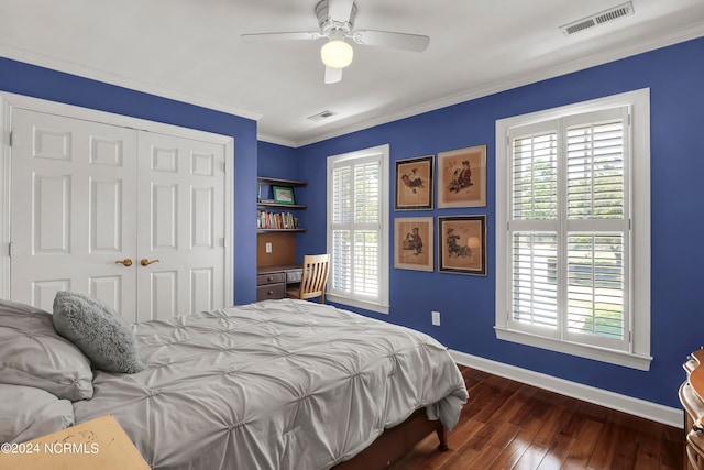 bedroom featuring multiple windows, a closet, ceiling fan, and dark hardwood / wood-style floors