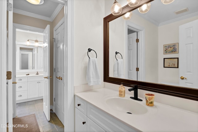 bathroom featuring tile patterned floors, ornamental molding, and vanity