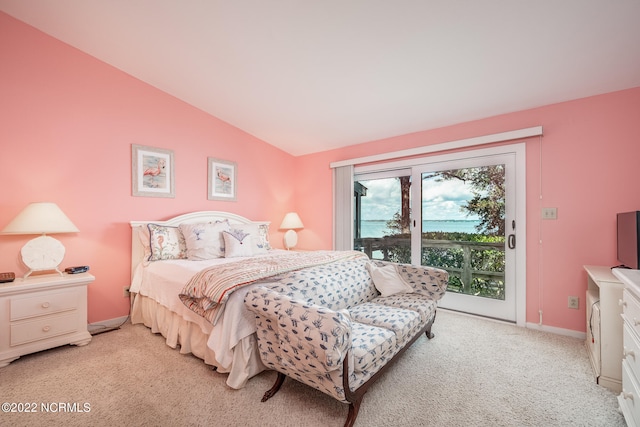 bedroom featuring access to exterior, vaulted ceiling, and light colored carpet