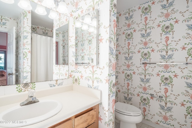 bathroom featuring vanity and toilet