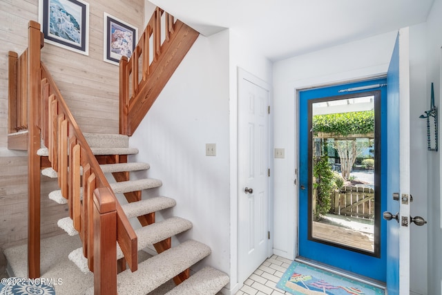 entryway featuring wood walls