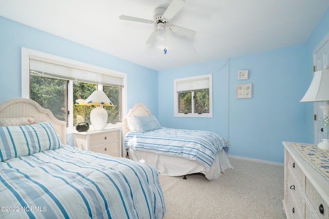 bedroom with ceiling fan and light carpet