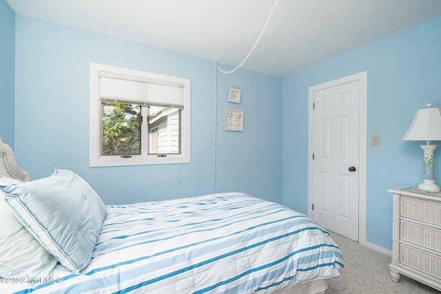 bedroom featuring light carpet