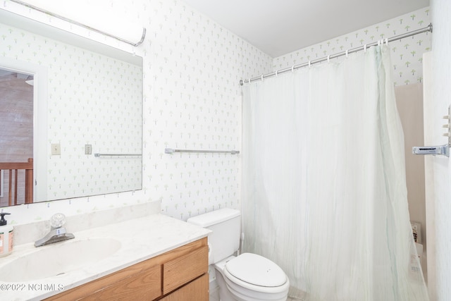 bathroom featuring vanity, toilet, and a shower with curtain