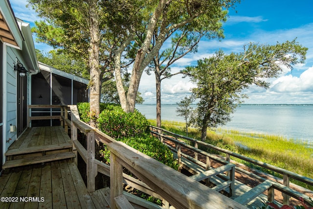 wooden deck featuring a water view and a sunroom