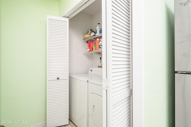 clothes washing area with washer and clothes dryer