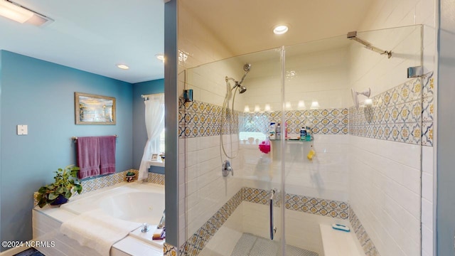 bathroom with shower with separate bathtub