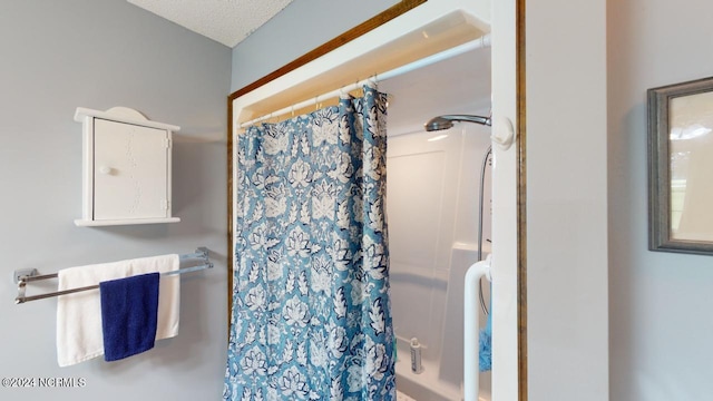 bathroom with walk in shower and a textured ceiling