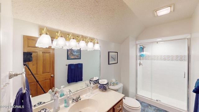 bathroom featuring a textured ceiling, lofted ceiling, a shower with shower door, vanity, and toilet