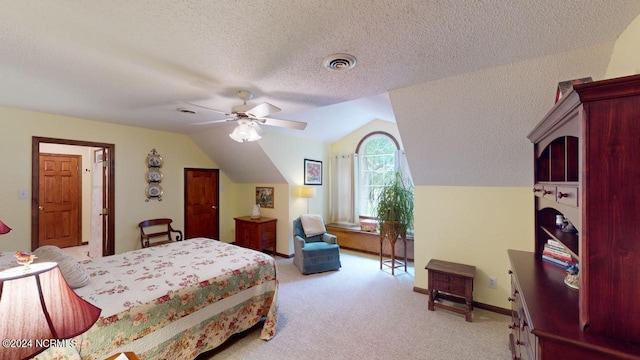 carpeted bedroom featuring ceiling fan, a textured ceiling, and lofted ceiling