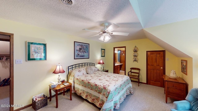 bedroom with a textured ceiling, ceiling fan, light colored carpet, and a closet