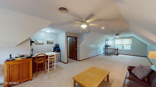 home office with lofted ceiling, ceiling fan, and light carpet