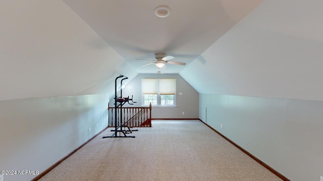 bonus room with vaulted ceiling, ceiling fan, and light colored carpet