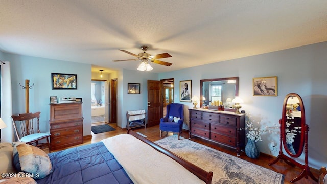 bedroom featuring connected bathroom, ceiling fan, hardwood / wood-style floors, and a textured ceiling