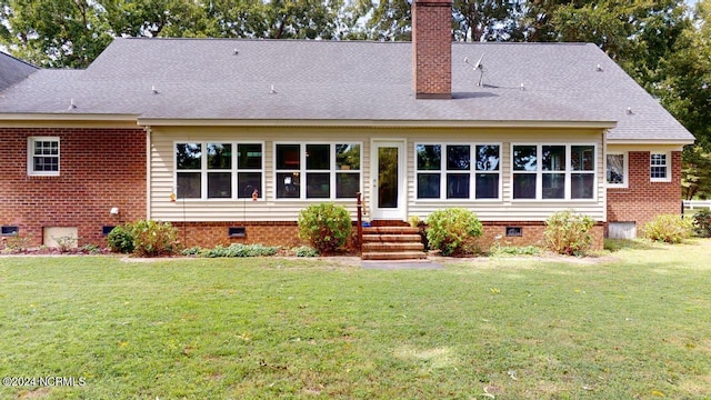 rear view of house with a yard