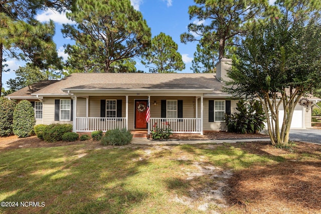 ranch-style house with a garage, a porch, and a front lawn