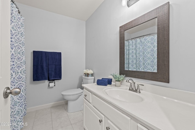 bathroom featuring tile patterned floors, baseboards, toilet, and vanity