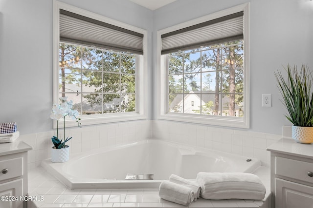 bathroom with vanity, a garden tub, and plenty of natural light