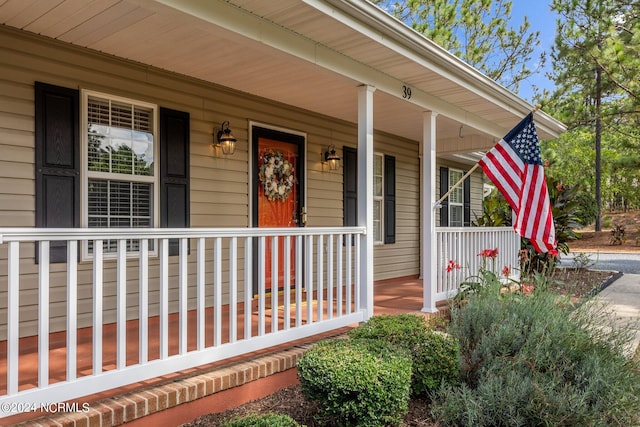 view of exterior entry featuring a porch